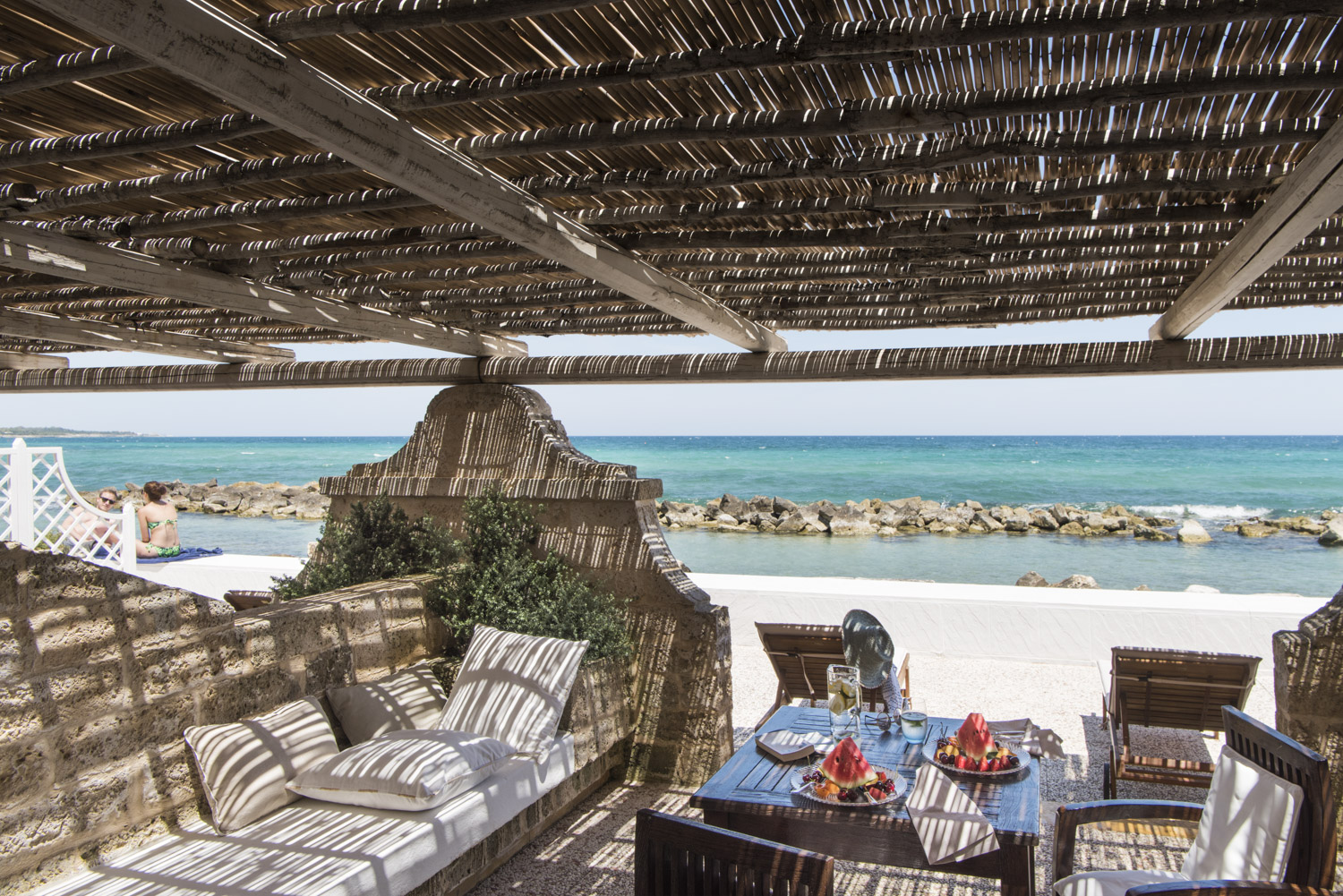 Set table with fresh fruit in a terrace of bedroom 102 at La Peschiera in Monopoli